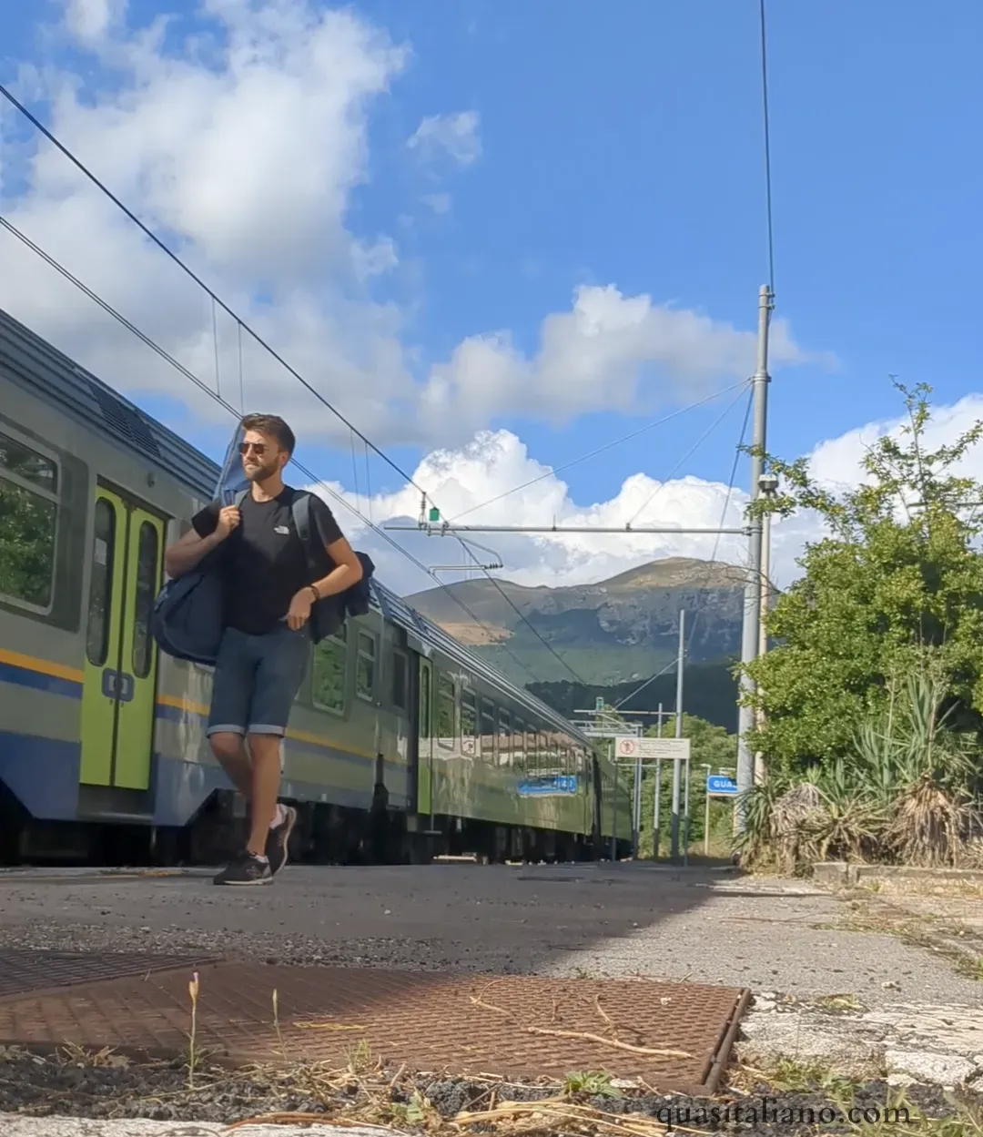 picture of me walking next to a train with mountains in the background