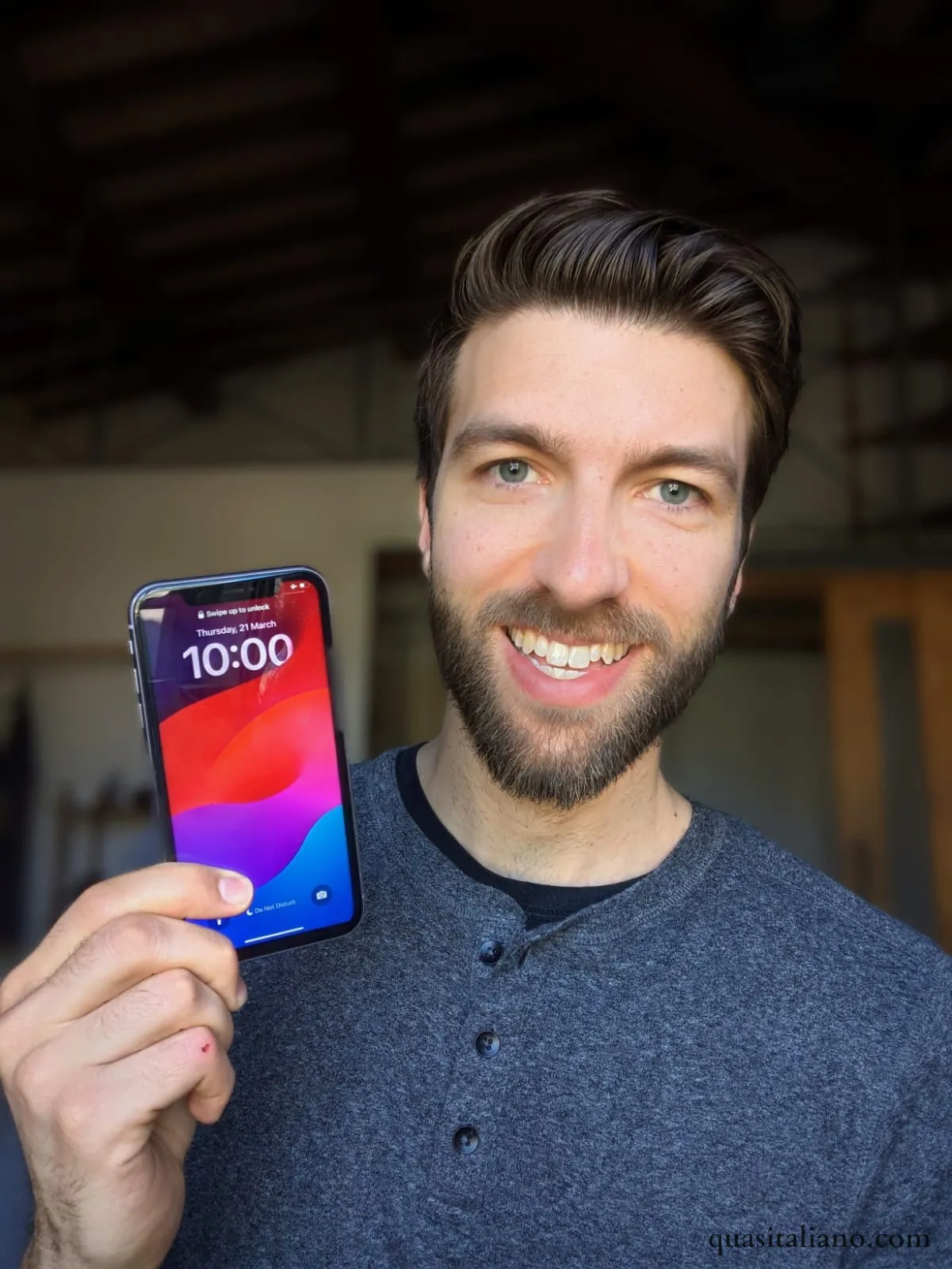 picture of guy holding Iphone