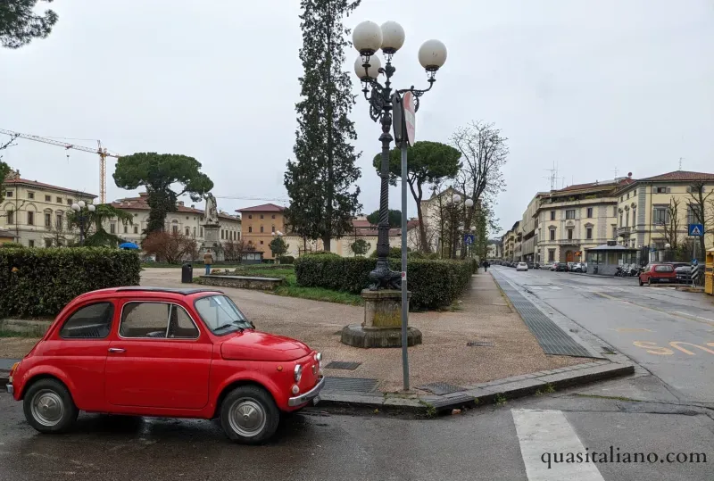 a bright red fiat at a stoplight in Florence