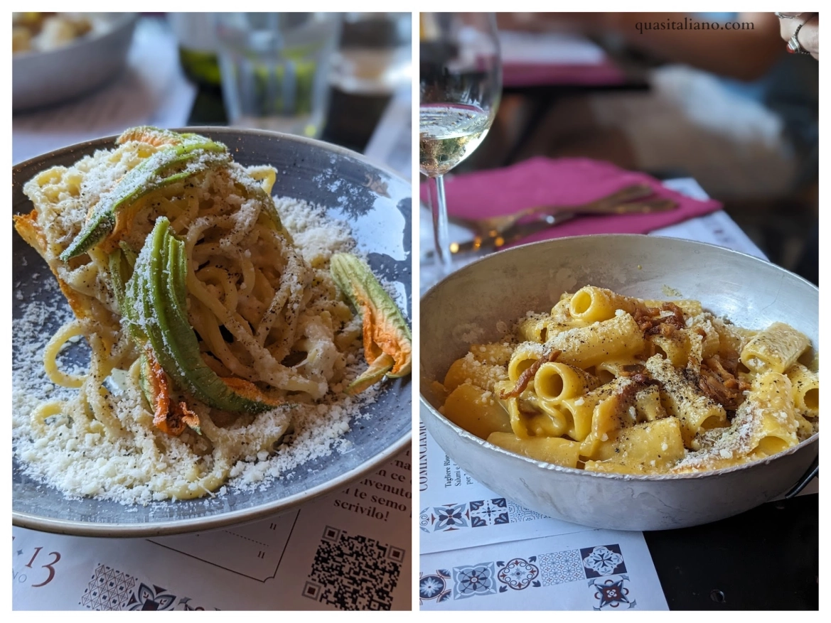 Two pasta dishes from Rione 13 in Rome: a plate of cacio e pepe with zucchini flowers on the left, and a bowl of carbonara topped with crispy guanciale on the right, served with a glass of white wine