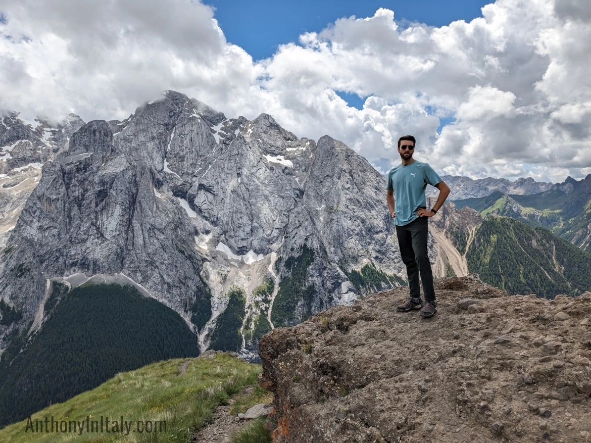 picture of anthony standing on a rock with the italian dolomites in the background