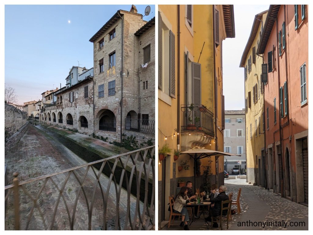 Evening view of the old canal and medieval arcades in Foligno, and colorful side street with people dining outdoors at a café