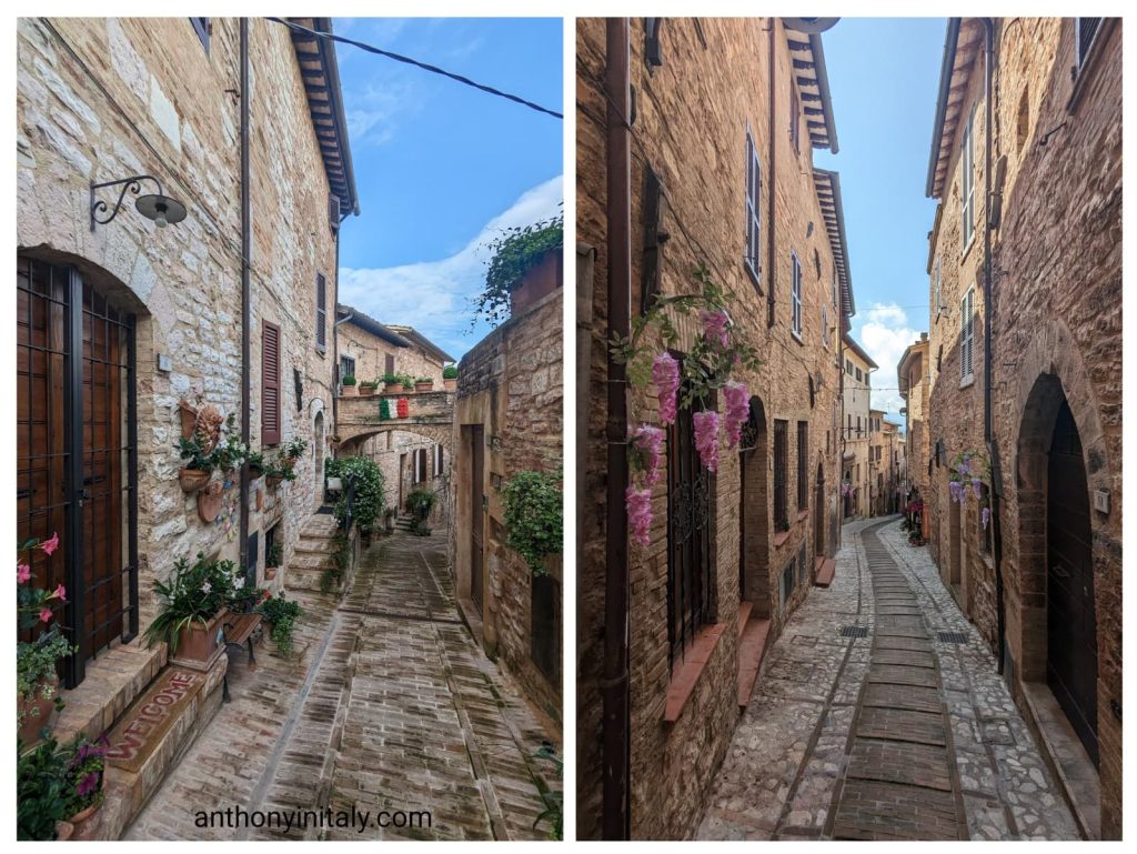Picturesque stone alleyways in Spello, Umbria, lined with flowers, arches, and rustic doors under the afternoon light.