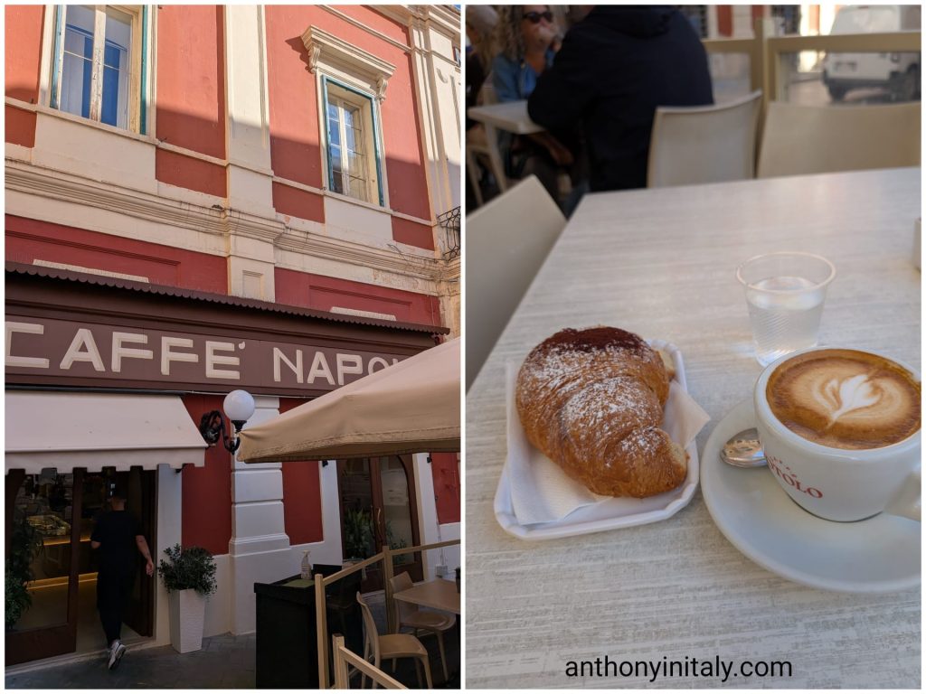 Red facade of Caffè Napoli in Monopoli, and a cornetto with a cappuccino on an outdoor table