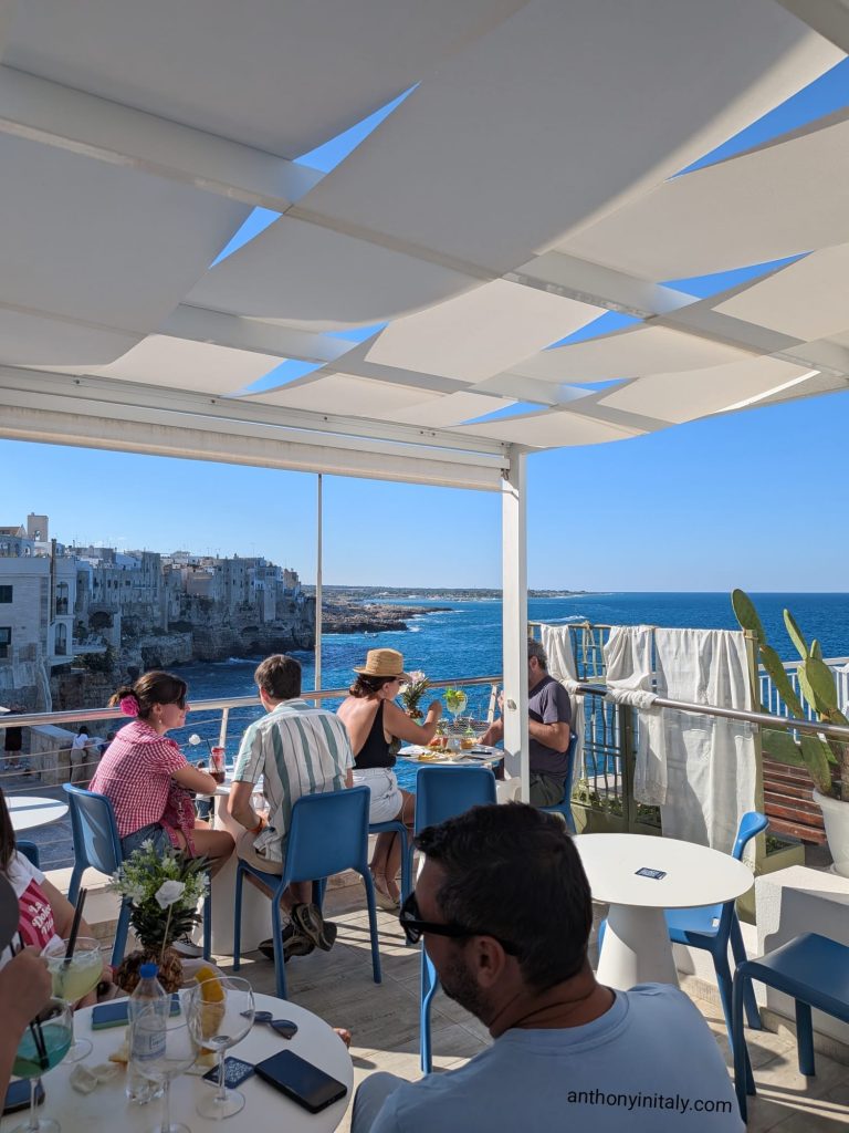 Rooftop bar terrace at Bellavista Tasting Emotion overlooking the cliffs and sea of Polignano a Mare