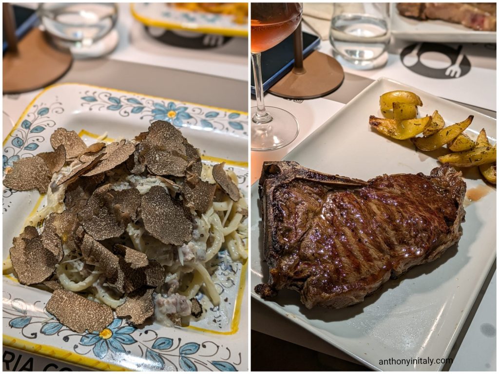 Strangozzi alla norcina with sausage and shaved black truffle on a painted ceramic plate, next to a grilled bone-in steak with roast potatoes at Trattoria Oberdan in Perugia